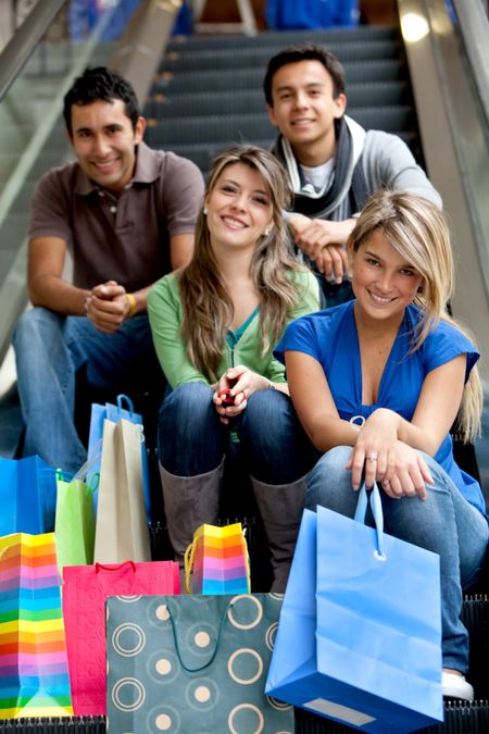 Shopping people sitting on the escalators at a mall