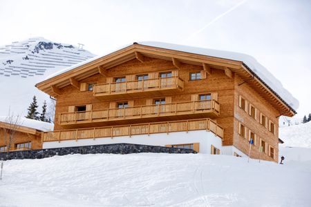 Beautiful winter house on wood and bricks in a snow montain