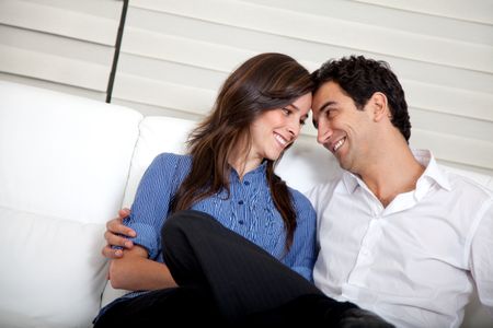 Beautiful loving couple at home hugging and smiling