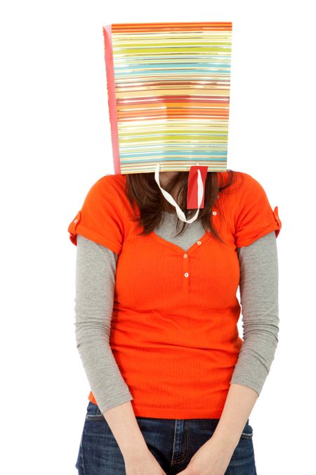 Woman with a shopping bag on her head isolated over a white background