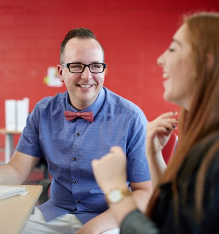 Unposed group of creative business people in an open concept office brainstorming their next project.