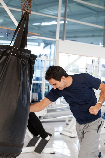 Athletic man boxing at the gym while training