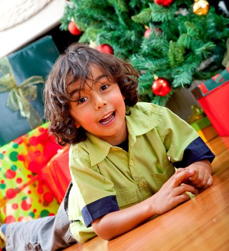 Happy kid next to a Christmas tree