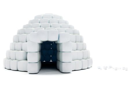 Igloo made with snow cubes isolated over a white background