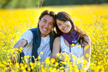 Lovely casual couple at a meadow smiling