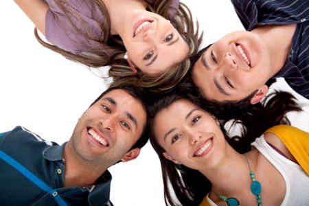 Happy group of friends with their heads together isolated over white