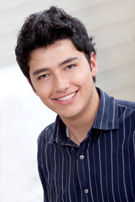 Handsome young man portrait at home and smiling