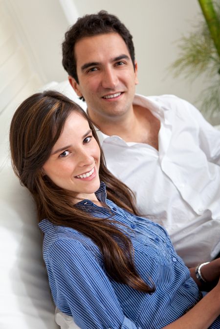 Beautiful young loving couple at home smiling