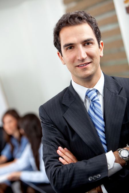 confident young executive at the office smiling