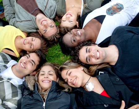 Circle of friends lying on the floor outdoors