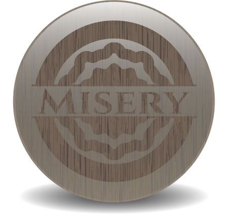 Misery badge with wooden background