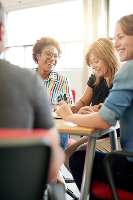 Unposed group of creative business people in an open concept office brainstorming their next project.