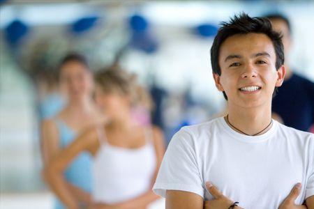 young man smiling and looking happy at the gym