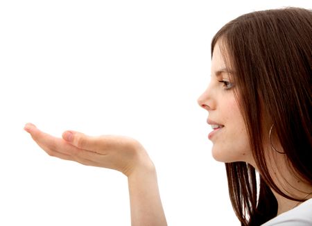 Woman holding something in her hand isolated over a white background