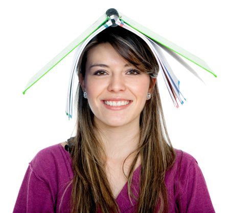 Happy female student with a notebook on top of her head isolated