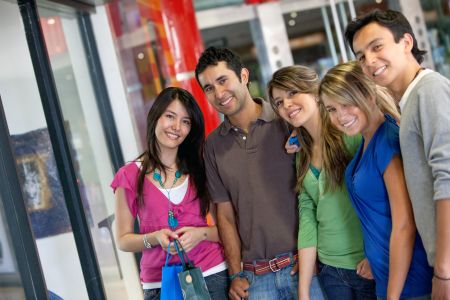 Group of friends shopping in a mall with some bags