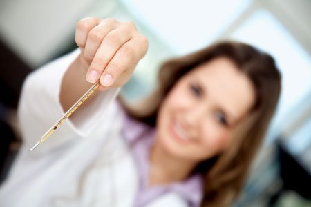 Female doctor holding a thermometer at a hospital