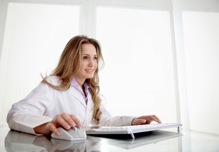 Female doctor working with a computer at a clinic