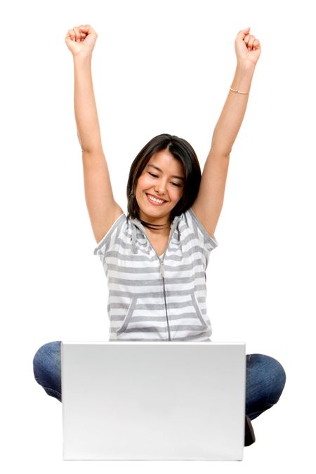 Beautiful excited girl with a laptop isolated on white