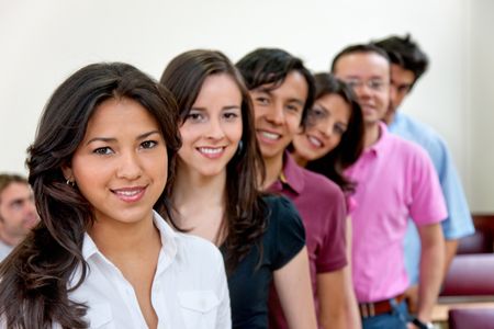 Group of happy students at the classroom smiling