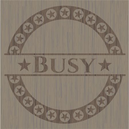 Busy badge with wooden background