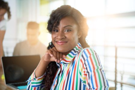 Image of a succesful casual business woman using laptop during meeting