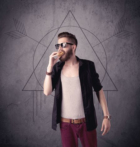 A young hipster male in modern clothes standing in front of an urban wall with modern sign illustration concept