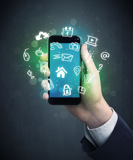 Caucasian hand in business suit holding a smartphone with drawn web icons