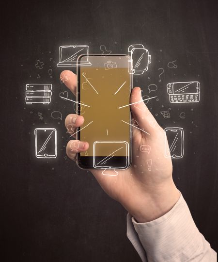 Caucasian hand in business suit holding a smartphone with hand-drawn icons