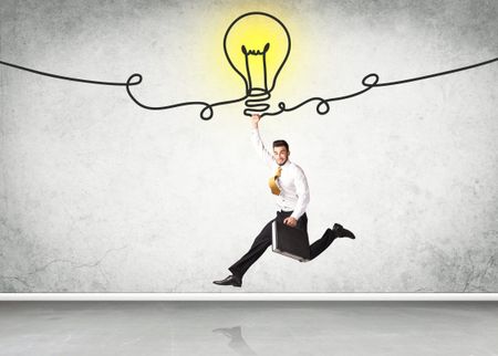 businessman-hanging-idea-bulb-420810499 Businessman hanging on an idea bulb