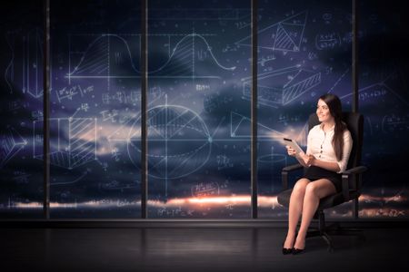 Businesswoman holding tablet in office room with graph charts on window concept