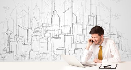 Businessman sitting at the white table with hand drawn buildings in the background