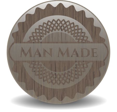 Man Made badge with wooden background