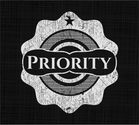 Priority chalkboard emblem on black board