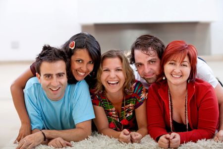 Happy group of friends lying on the floor and smiling