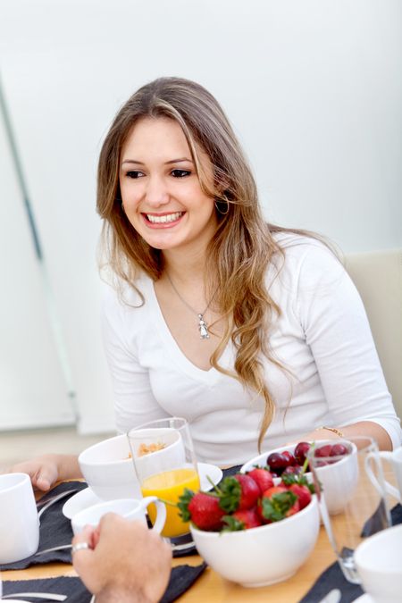 Beautiful woman eating her breakfast at home