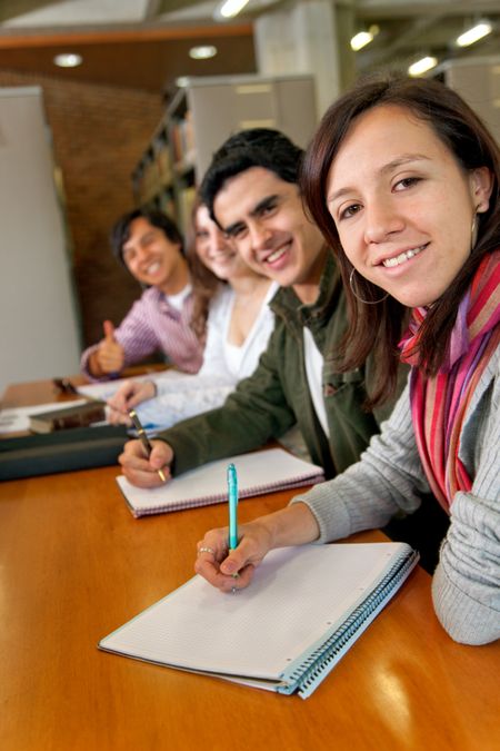 Group of students at a library and smiling