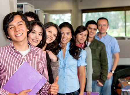 Group of students at the library smiling