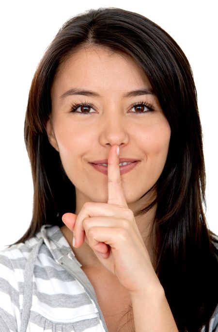 Woman making a silence sign isolated over a white background
