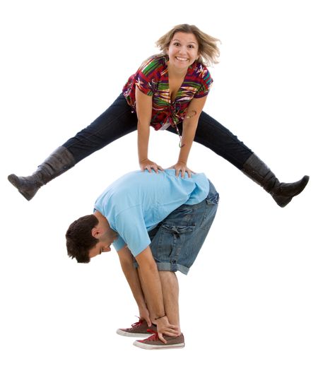 Happy woman excited jumping over a man isolated on white