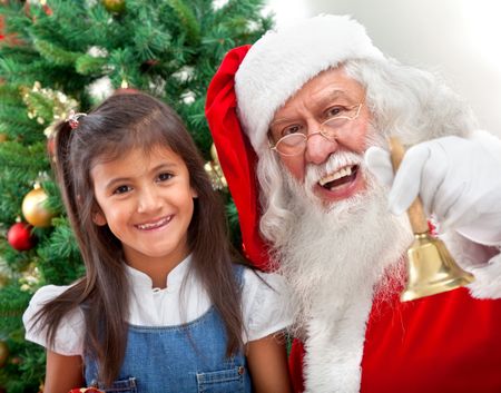 Christmas portrait of a girl with Santa Claus smiling