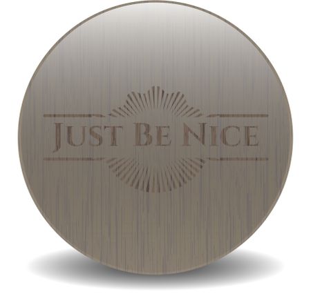 Just Be Nice badge with wooden background