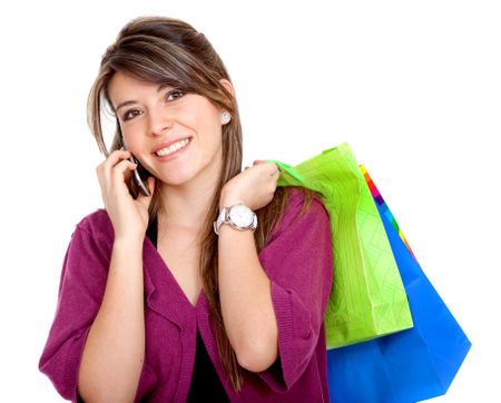 happy woman smiling on the phone with shopping bags - isolated over white