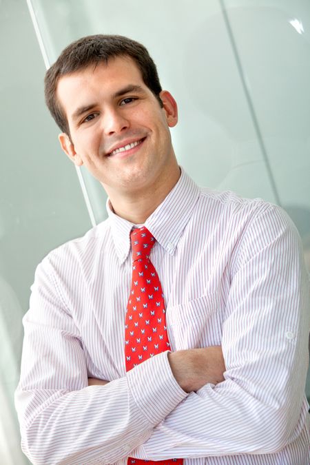 Friendly business man portrait - smiling in his office