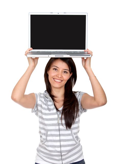 beautiful woman displaying a laptop computer on top of her head isolated over a white background