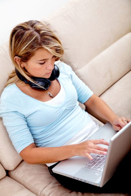 Casual student studying on a laptop computer at home