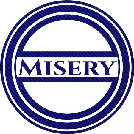Misery badge with denim background