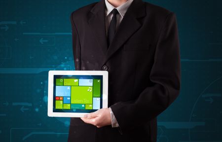 Young businessman holding a tablet with modern software operational system