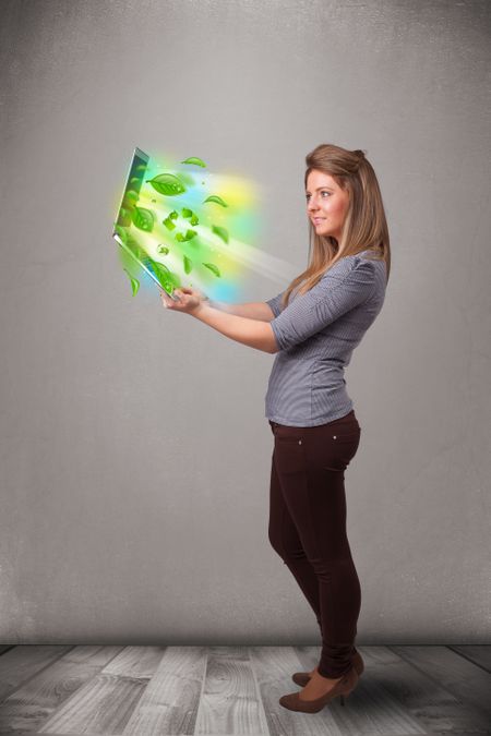 Casual young woman holding notebook with recycle and environmental symbols