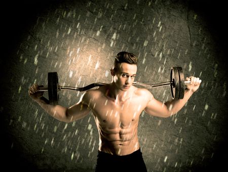 handsome-young-body-builder-weightlifting-showing-424182214 A handsome young body builder weightlifting while showing his muscular upper body in the rain concept